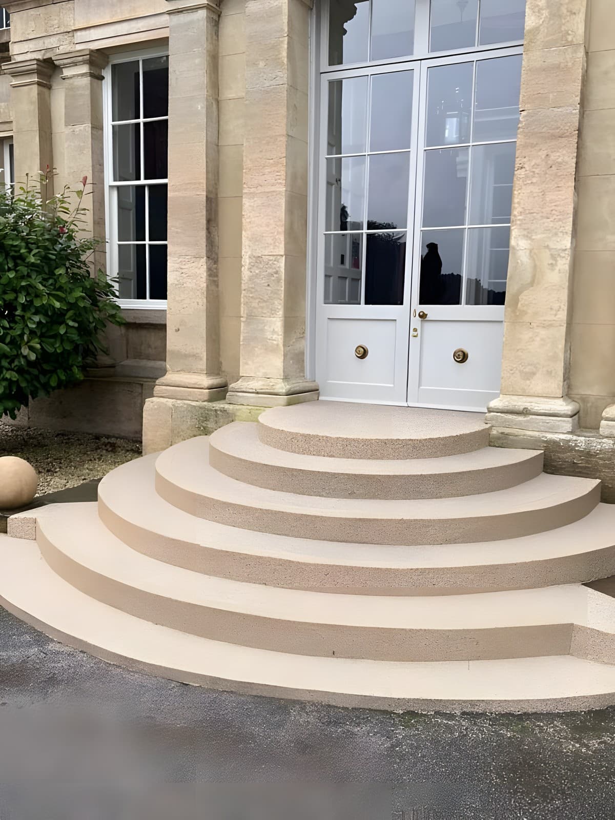 Curved Resin Rock entry steps sweeping up to a manor doorway